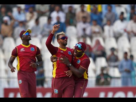 West Indies captain Nicholas Pooran (centre) celebrates with teammates after taking the wicket of Mohammad Rizwan during the third and final one-day international cricket match between Pakistan and West Indies at the Multan Cricket Stadium, in Multan, Paki