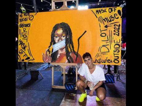 Visual artist Simone Williams posing proudly with her artwork painted live at the recently staged Di Lot event, which she took three hours to create. 