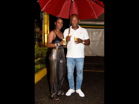 Cosy under their umbrella were Jonelle Williams and Donovan Betancourt, who were well prepared for the rain which came tumbling down.