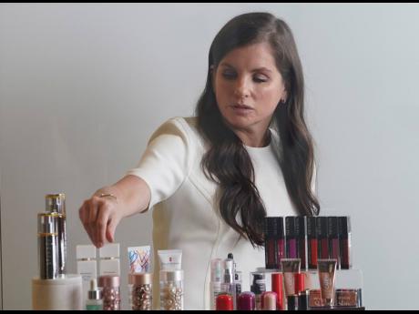 
Revlon CEO Debra Perelman, the company’s first woman CEO in its 89-year-old history, show products during an interview, Wednesday August 18, 2021, in New York.