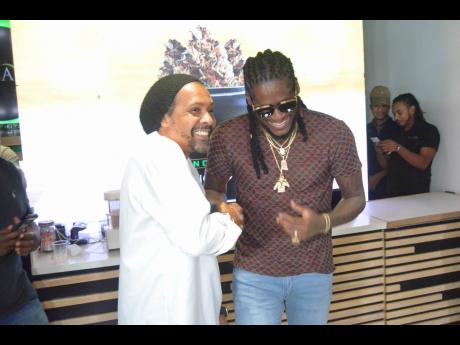 Epican Brand Ambassador Aidonia is greeted by Epican President Dwayne McKenzie (right), as he arrives at the launch of the new cannabis strains on Wednesday.