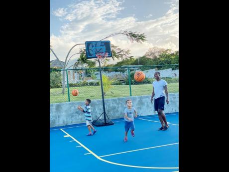 Stevens in daddy mode, playing basketball with his two boys. 