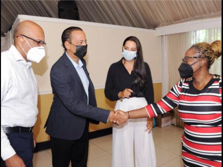 Ramsay McDonald (left), Deputy Chairman, JPS Foundation and Lauri-Ann Ainsworth (second right), CEO, Branson Centre of Entrepreneurship-Caribbean, look on as Gary Barrow (second left), Chief Operating Officer – JPS, greets Clare Bailey (right), Head of P