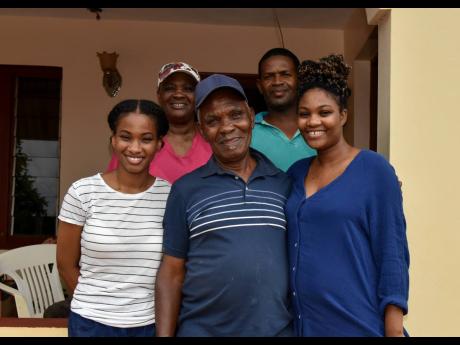 
Garfield Swaby (centre) and his family. From left (back row): wife Hermina; family friend, Clive Thomas and (front row) granddaughters Keshia and Shanniel. Swaby spoke about what it takes to be a good father and some of the hardships he faced to accomplis