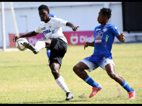Lamounth Rochester  (left) of Cavalier controls the ball ahead of Alwayne Harvey of Mount Pleasant during a Jamaica Premier League match at Sabina Park on March 20. The game ended in a 0-0 draw.