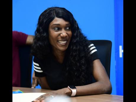 Natoya Goule Toppin is all smiles at the signing ceremony where she was announced the brand ambassador for the Recycling Partners of Jamaica, yesterday. 