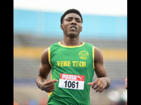 Jayval Wright of Vere Technical High School makes his way into the main draw of the men's 100 metres at the National Senior and Junior Championships at the National Stadium this evening. Wright won his heat in 10.40 seconds.
