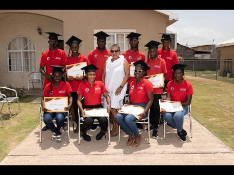  Ruth Jankee, executive director of the Rose Town Foundation, stands with the interns at their graduation.