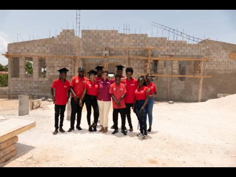 Christine Gore, executive director of the Gore Family Foundation, proudly stands with the interns at the community centre that they are building at Gore Developments Limited’s Phoenix Park site. 