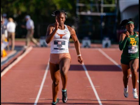 Kevona Davis (left) of the University of Texas  in action at the Big 12 Conference meet. 