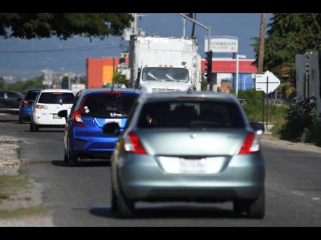 Motorist travel along Braeton Parkway in Portmore, St Catherine, on Sunday. With the PriceSmart megastore set to open in months, traffic pile-ups are expected to escalate.