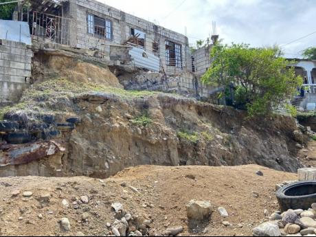 Homes built on unconsolidated sand and gravel on the hills behind Southern Cross Drive which, as a result, has made their slopes unstable.