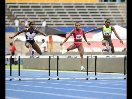 
Rushell Clayton (left) competes in a women’s 400-metre heat at the JAAA National Senior and Junior National Athletics Championship inside the National Stadium. Also in the race are Andranette Knight (centre) and Shiann Salmon.