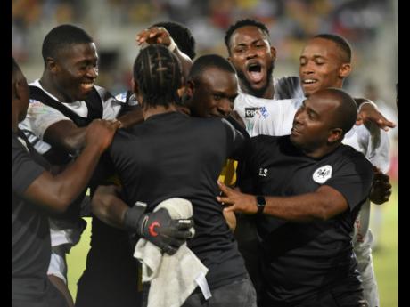 Akel Clarke (centre), Cavalier SC goalkeeper, celebrates with members of the coaching staff after he saved two penalties to beat Mount Pleasant United 4-3 in a penalty shootout at Sabina Park to advance to the semi finals of the Jamaica Premier League on T