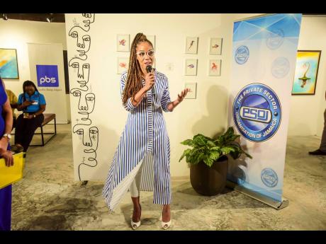 Imega Breese McNab, PSOJ executive director, fashionably welcomes members to the organisation’s second mingle for the year at the scenic Sky Gallery last Thursday.