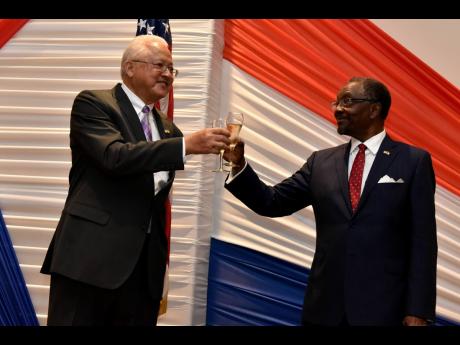 Minister of Justice Delroy Chuck (left) shares a toast with United States Ambassador N. Nick Perry at The Jamaica Pegasus Tuesday evening during a celebratory event in the lead-up to the US’s 246th anniversary of independence. America celebrates Independ