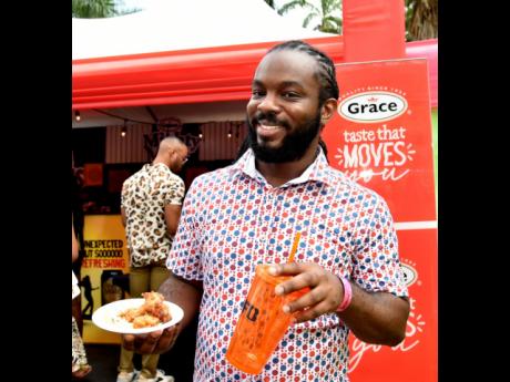 Jomo Blake enjoyed a serving of sweet and spicy fish from the Grace booth. 