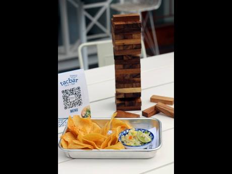 The food is fun, but so is the table setting, so diners can order a serving of nachos and dip, pull out the mini Jenga blocks and play until the main course is ready.