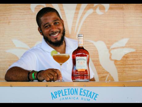 Showing off the Brown Sugar Daiquiri, mixologist Milton Wisdom, who likes to serve up some comedy, says it always comes with a smile that’s just as sweet.