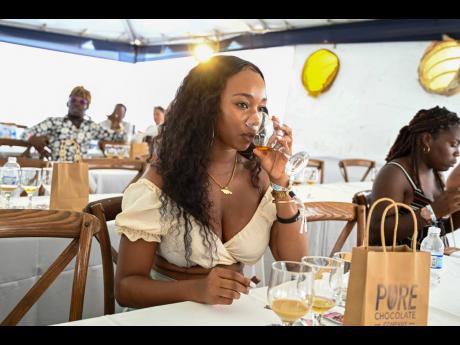 Participant in the Jamaica Rum Festival ‘Pots and Pods’ Rum seminar, Content Creator Suetanya Mchorgh, sips the medium-bodied aged Worthy Park Select Jamaica rum. 