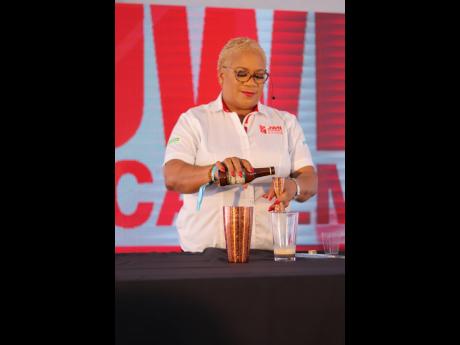Lead Instructor Sharmon Hinds-Smith demonstrates to patrons how best to create Chocolate Earthquake, a simple but delicious cocktail made with chocolate syrup and rum cream. 