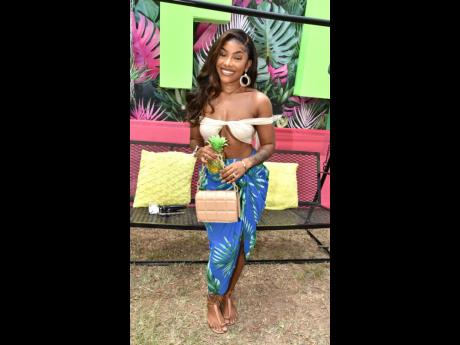 Sue-Ann Gordon Pitter upped the style quotient at last Saturday’s Rum for Breakfast. The YouTuber, who is better known as  Petite-Sue Divinitii, paired a tropical wrap skirt and a bandeau crop top. 