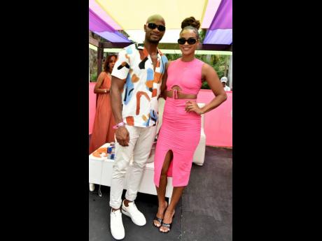 We love a stylish couple! Asafa Powell (left) donned an abstract print shirt, while his wife, Alyshia, was pretty as  a picture in fuchsia pink separates.