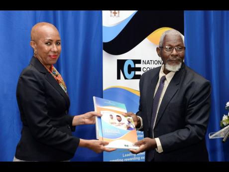 Fayval Williams (left), minister of education and youth, accepting a copy of the National Education Sector Plan from Professor Disraeli Hutton, council member, National Council on Education, on Wednesday at The Jamaica Pegasus hotel after the launch of the