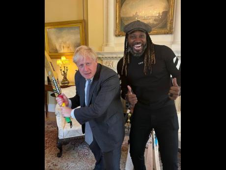 British Prime Minister Boris Johnson (left) and cricket star and artiste Chris Gayle, an ambassador for Jamaica.
