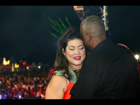 A proud Brandon Crooks, embraces his wife, Tessanne Chin, following her 2022 Jamaica Rum Festival performance. 
