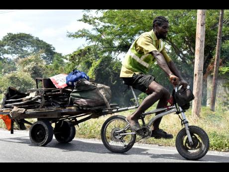 Thirty-nine-year-old scrap-metal dealer Leon Binnie rides his customised bicycle along the Chesterfield main road in Kingston on Thursday, June 2. World Bicycle Day is observed annually on June 3 and acknowledges the longevity and versatility of the vehicl
