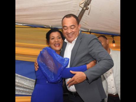 Health and Wellness Minister Dr Christopher Tufton embraces Sandra Molyneaux, new president of the Rotary Club of Savanna-la-Mar, during the club’s annual installation ceremony at Guangos Jerk in the Westmoreland capital on Saturday.