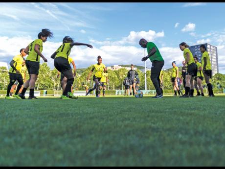 Assistant coach Lorne Donaldson joins Reggae Girlz  in drills during a training session in 2019 ahead of  a World Cup match against Australia. 