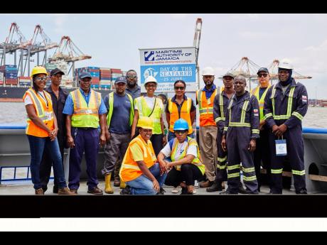 The MAJ team hands out Day of the Seafarer tokens to the team from Ocean Towing, Kingston Harbour.