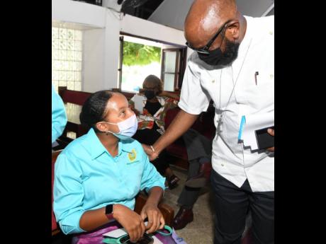 Imani-Leigh Hall, founder of ILAH’s Lemon-Aid Stand for Kids Foundation, chats with the Reverend Astor Carlyle, pastor of the Webster Memorial Church, at the launch of the foundation’s 2022 summer camp at the Half-Way Tree Road-based church on Monday.