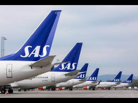 SAS planes are grounded at Oslo Gardermoen airport during pilots strikes, in Oslo, Friday, April 26, 2019. 