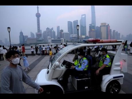 Chinese policemen patrol the bund area on June 1 in Shanghai.