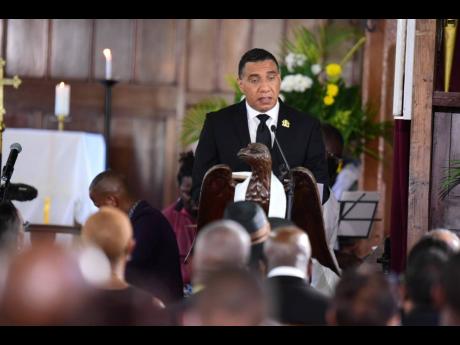 Prime Minister Andrew Holness reading the first lesson at the official funeral service for former minister of government Shahine Robinson. 
