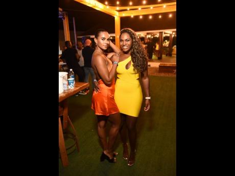 Alyshia Miller Powell (left) and  Liane Chung Barakat were picture-perfect at the Grand Excelsior Hotel in Port Royal last Friday for Andrew Bellamy’s birthday party.