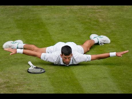 Serbia’s Novak Djokovic reacts after making a passing shot to Italy’s Jannik Sinner in a men’s singles quarter-final match on day nine of the Wimbledon tennis championships in London yesterday.