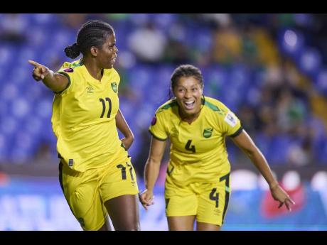 Reggae Girlz captain Khadija Shaw (left) and teammate Chantelle Swaby celebrate after opening the scoring against Mexico in a Group A Concacaf Women’s Championship match on Monday.