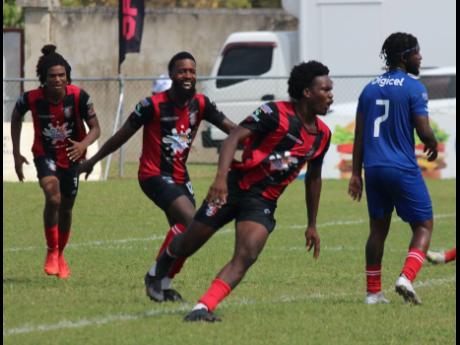 Arnett Gardens goalscorer Luca Kong (right) runs away from his teammates after scoring in a Jamaica Premier League match.