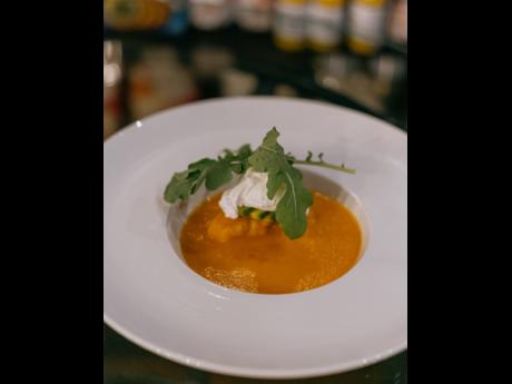 The velvety tomato soup accompanied by fricassee snapper, avocado, poached eggs, and arugula. 