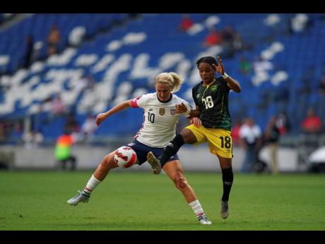 United States' Lindsey Horan (left)  and Jamaica's Trudi Carter vie for the ball during a Concacaf Women's Championship match in Monterrey, Mexico on Thursday, July 7, 2022. 