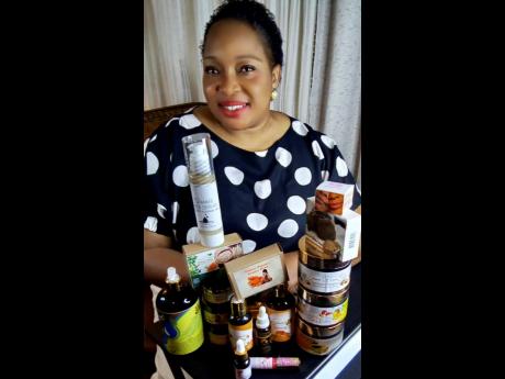Meet the beauty behind Simmie Skin Care, Simone Myrie Dawson, beaming with great pride among her line of products.