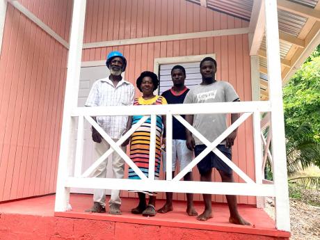 (From left) Glenford Fearon; his wife, Yvonne, and their twin boys on the veranda of their new house, which was a Father’s Day gift.