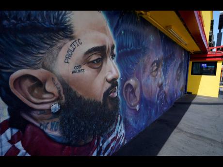The many murals of Nipsey Hussle around Los Angeles speak to the late rapper’s lasting legacy, including the mural near his closed The Marathon Clothing store in Los Angeles.