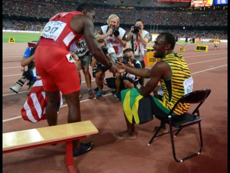 
Justin Gatlin congratulates Usain Bolt after the latter pipped him to the line in the men’s 100-metres final at the 15th IAAF World Championships in Beijing, China.