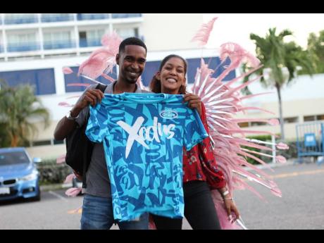 Schaunn-Anthony Thomas (left) and Kelicia Williams collect their Xodus costumes at the Jamaica Pegasus hotel ahead of Sunday’s road march.