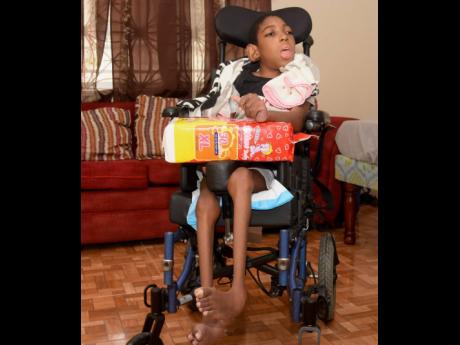 Nine-year-old son Devonte Williams, diagnosed with cerebral palsy poses for a photo in his new wheelchair.